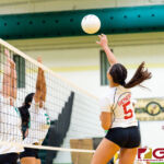 St. John's Knight Tylee Shepherd spikes over Islanders Frencine Villena and Kamalynne Lizama. (Photo by Michael Blas)