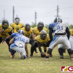 The Eagles center Jesse Flickinger gets ready to hike the ball to his Qb while the Cowboy defenders get set to attack. (photo by Bout It Productions)