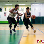 St. Paul Warriors Nichika Fermin steps his way towards the basket while JFK Islanders Lawrence Tisalona keeps the pressure on. (Photo by Michael Blas)