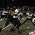 Guam High Panthers Avery Gamboa wraps up JFK Islanders Dysseus Quintanilla for the offensive play. (photo by Bout It Productions)