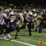 Tiyan High Titans Christopher Cowart strides through the Panthers defense. (photo by Bout It Productions)
