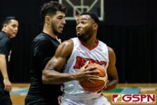 KFC Bomber Divine Cox powers his way towards the basket while being defended by Wu Tangs Amir Khozhlev. (Photo by Michael Blas)
