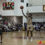 Team Elite's Tony Quinene shoots from beyond the arch while Team Supreme's Jahmar White looks on. (photo by Bout It Productions)