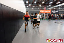 Athletes take a jog around the mat to warm up before learning new techniques. (Photo by Michael Blas)