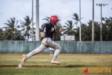 JFK Islanders Zavier Camacho hustles on the sidelines to first base. ( Photo by Bout It Productions )