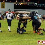 JFK Islanders Jacobe Quinata drives through the Dolphins defense for the first down. (Photo by Michael Blas)