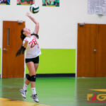 Knight's Eli Errett serves ball over to the Islanders near the end of the third set. (Photo by Michael Blas)