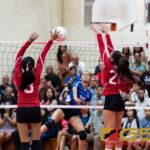 Notre Dame Royals Minami Rabago's spikes while St. John's Knights Raina Patague gets a hand on the ball. (Photo by Michael Blas)