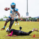 Angels Jermaine Molo slips out of a tackle to gain more yardage on the play. (Photo by Michael Blas)