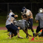 Guam High Panthers Rasean Jacobs drives the ball towards the end zone while Simon Sanchez Sharks Joshua Relativo drives him back. (Photo by Michael Blas)