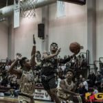 Team Supreme's Jahmar White gets around Team Elite defenders for the bucket. (photo by Bout It Productions)