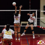 St. John's Knight Hallee Wigsten sends the ball past Gecko blocker Kirsten Santos. (Photo by Michael Blas)