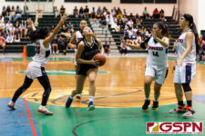 St. Paul Warrior Jan Quintanilla finds a seam through the Bulldog defense and drives the ball in for two points late in the fourth quarter. (Photo by Michael Blas)