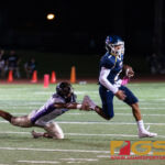 Guam High Panther's Travon Jacobs slips past GW Geckos' LB Jerome Quichocho. (Photo by Michael Blas)