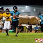 Southern Dolphin QB Ethaniel Escuadra dodges Friar defenders for time to throw. (Photo by Michael Blas)