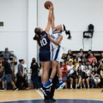 Academy Cougars Mia San Nicolas and St. Paul Warriors Niah Siguenza jump ball at the start of their 2018 IIAAG high school girls basketball game. (Photo by Michael Blas)