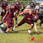 Father Duenas Friar's Kein Artero breaks through several tackles and regains his footing to score a touchdown. (Photo by Michael Blas)
