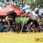 Raiders Peter Mesa looks to gain yards as Angels Vance Meno goes in for the tackle. (Photo by Michael Blas)
