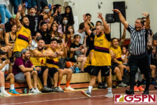 '06's Mike Sgro gets the sideline pumped up after going up big late in the second half. (photo by Michael Blas)