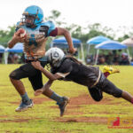 Raiders Aiden Palacios dives for Angels Vance Meno, making the tackle and preventing an Angels touchdown. (Photo by Michael Blas)