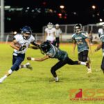 Player of the Game Jalen Thach stiff arms JFK Islander's Quintin Kakas after making a reception. (Photo by Michael Blas)