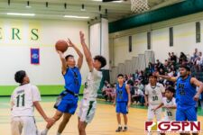 St. Paul Warrior Hayato Tsujii drives towards the basket against JFK Islander Dean Weilbacher. (Photo by Michael Blas)