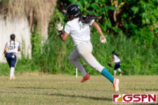 Southern Dolphin Vanesha Naputi runs to third as Academy Cougars outfielders chase down the ball. (Photo by Michael Blas)