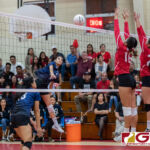 AOLG Ravyn Benavente sends the ball over the net while St. John's Knights Angeline Del Carmen and Eli Errett leap up to block. (Photo by Michael Blas)
