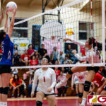ND Royals Nicolette Perez gets a touch on a spike from St. John's Knight Hallie Wigsten. (Photo by Michael Blas)