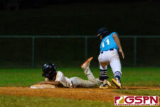 GW Gecko Aiden Gumataotao dives for third base before ND Royal Ricardo Leon Guerrero can make the tag. (Photo by Michael Blas)