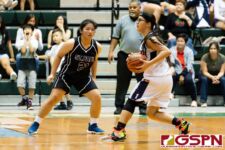 St. Paul Warrior Kat Santos maintains the pressure on defense while Okkodo Bulldog Angeli Dacanay looks for an opening. (Photo by Michael Blas)