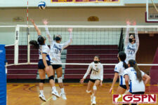 ND Royal Seniayath Bell reaches for a tip while Academy Cougar Jaeana Reyes defends. (Photo by Michael Blas)