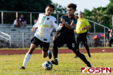 JFK Islander Russel Anicas looks for a cross with a Sanchez Shark defender pressuring. (Photo by Michael Blas)