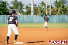 New Zealand's Hunter Sonthey launches the ball to Rodney Komene for an out at first base. (Photo by Michael Blas)