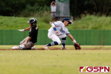 JFK Islander John Cruz slides into second base before ND Royal Ethan Lobaton can get to the ball on time. (Photo by Michael Blas)