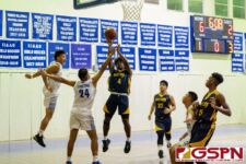 Guam High Panther Jayson Jackson gets up for a short range two pointer while ND Royal Kevin Tainatongo contests. (Photo by Michael Blas)