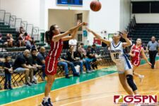 St. John's Knight Kaia Malakooti lets it fly from deep while St. Paul Warrior Kirsten Silva contests. (Photo by Michael Blas)