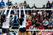St. John's Knight Hallie Wigsten spikes through Royals Faith Piper and Mikaila Genereux. (Photo by Michael Blas)