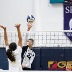 St. Paul Warriors Niah Siguenza looks for a kill shot while George Washington Geckos Ciarra Martinez leaps up to block. (Photo by Michael Blas)