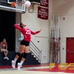 St. John's Knights Hallie Wigsten leaps up to serve the ball to the Notre Dame Royals. (Photo by Michael Blas)