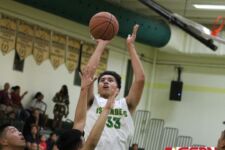 Islander Jeremiah Taitingfong attempts a jumper in the lane in the first half. (photo by Robert Balajadia)