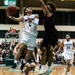St. Paul Warriors Jahmar White attacks the basket on a fast break while FD Friars Tony Quinene contests. (Photo by Michael Blas)