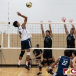 Harvest Eagles Mason Caldwell loads up for a spike as Titans Gary Ericsson and Neil Ericsson go up to contest. (Photo by Michael Blas)