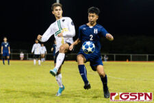 JFK Islander Noah Mueller and Harvest Eagle Jacob Lee fights for the ball as it makes its way out of bounds. (Photo by Michael Blas)