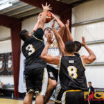 PFC Islanders crowd Guam Elite Friars Will Stinnett as he powers in for a shot at the net. (Photo by Michael Blas)