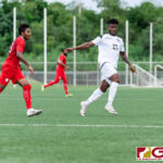 Guam Matao Forward Shane Malcolm keeps possession as Maldives Forward Hassan Naiz trails. (Photo by Michael Blas)