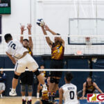 St. Paul Warriors Nichika Fermin looks for the kill while Friars Brandon Soriano gets up to block. (Photo by Michael Blas)