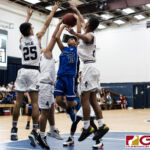 Bishop Obispos Aaron Santos pops for two points with three Warrior defenders on him. (Photo by Michael Blas)