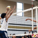 Harvest Eagles Jacob Oshiro blocks Titans Trevor Martinez early in the first set. (Photo by Michael Blas)