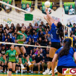 JFK Islander Kiana Rivera spikes while ND Royal blocker Faith Piper contests. (Photo by Michael Blas)